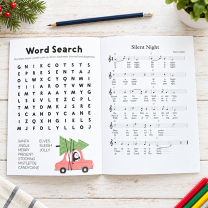 Open book with word search and sheet music on a wooden surface