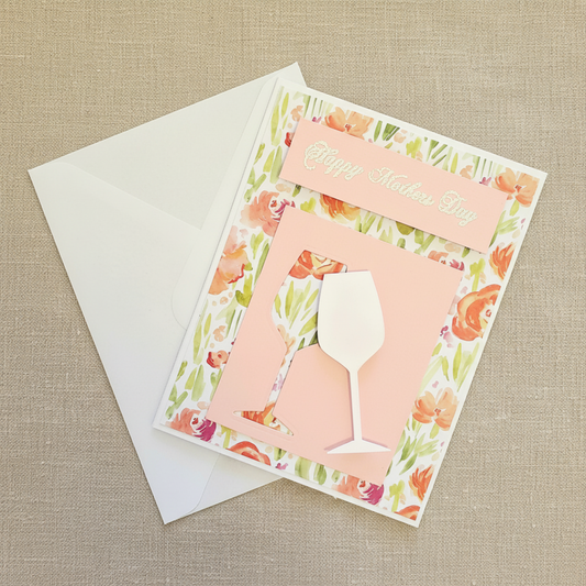 Greeting card with floral design and wine glass silhouette on a beige textured background